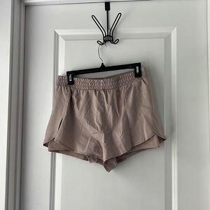 Blush running shorts with spandex shorts underneath. Girlfriend Collective